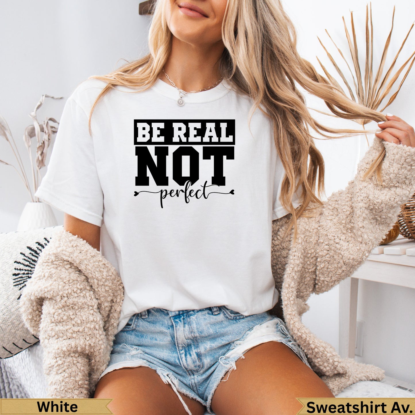 White t-shirt with "Be Real Not Perfect" text on the front.