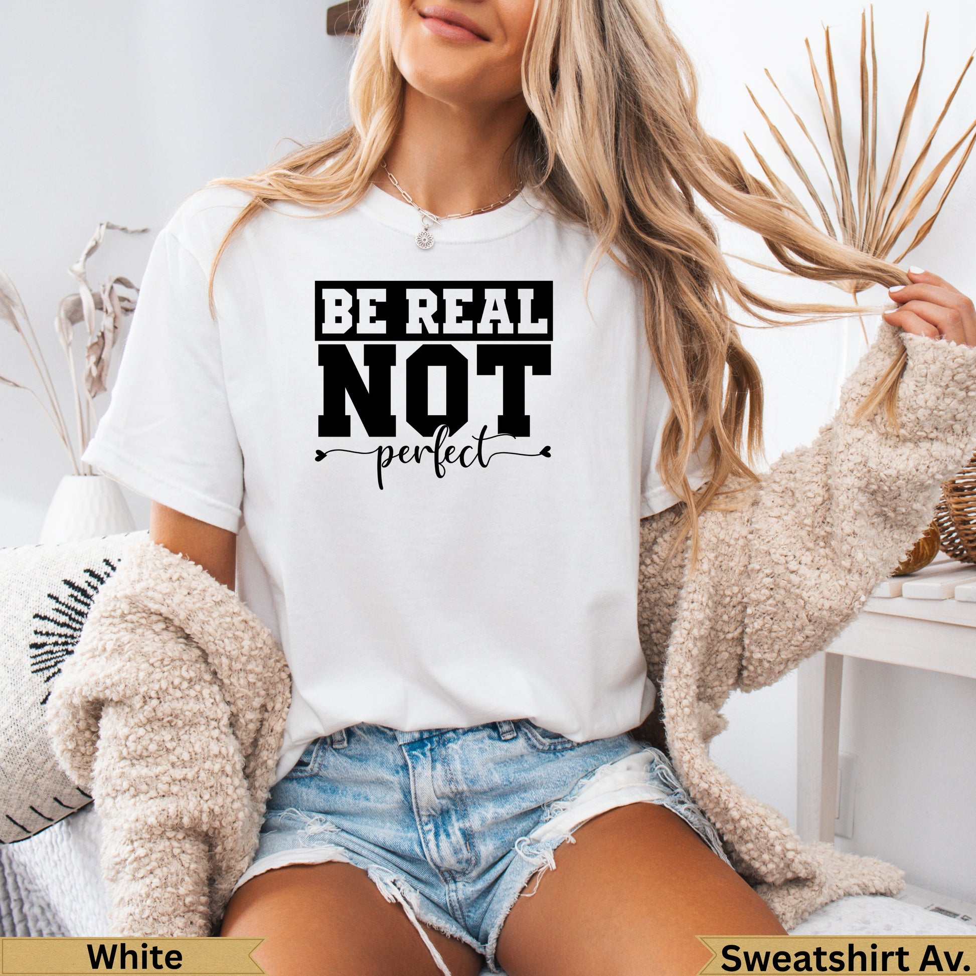 White t-shirt with "Be Real Not Perfect" text on the front.