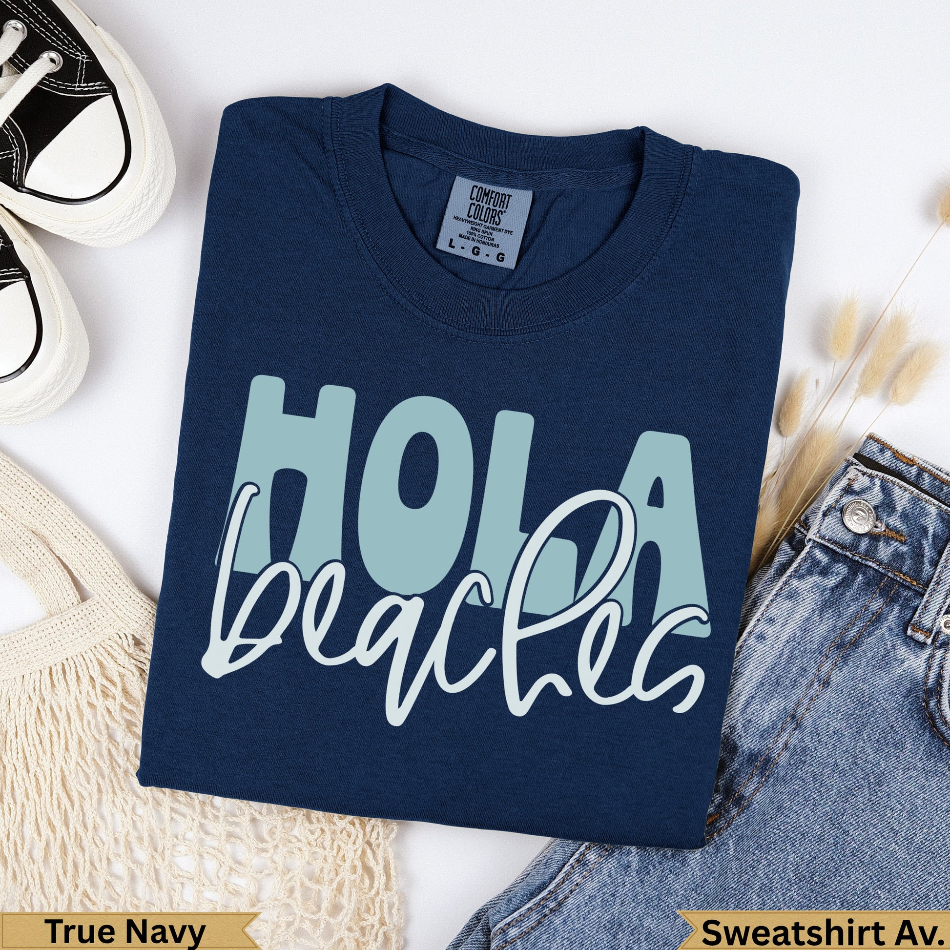 Navy blue t-shirt with "Hola beaches" graphic.