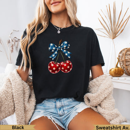 Black t-shirt with cherries and a blue bow graphic.