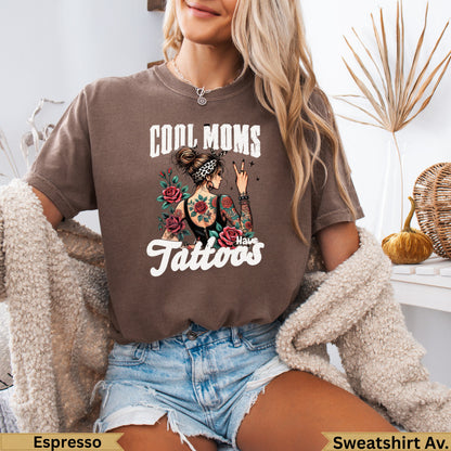 Brown graphic t-shirt with "Cool Moms Have Tattoos" text and floral rose design.