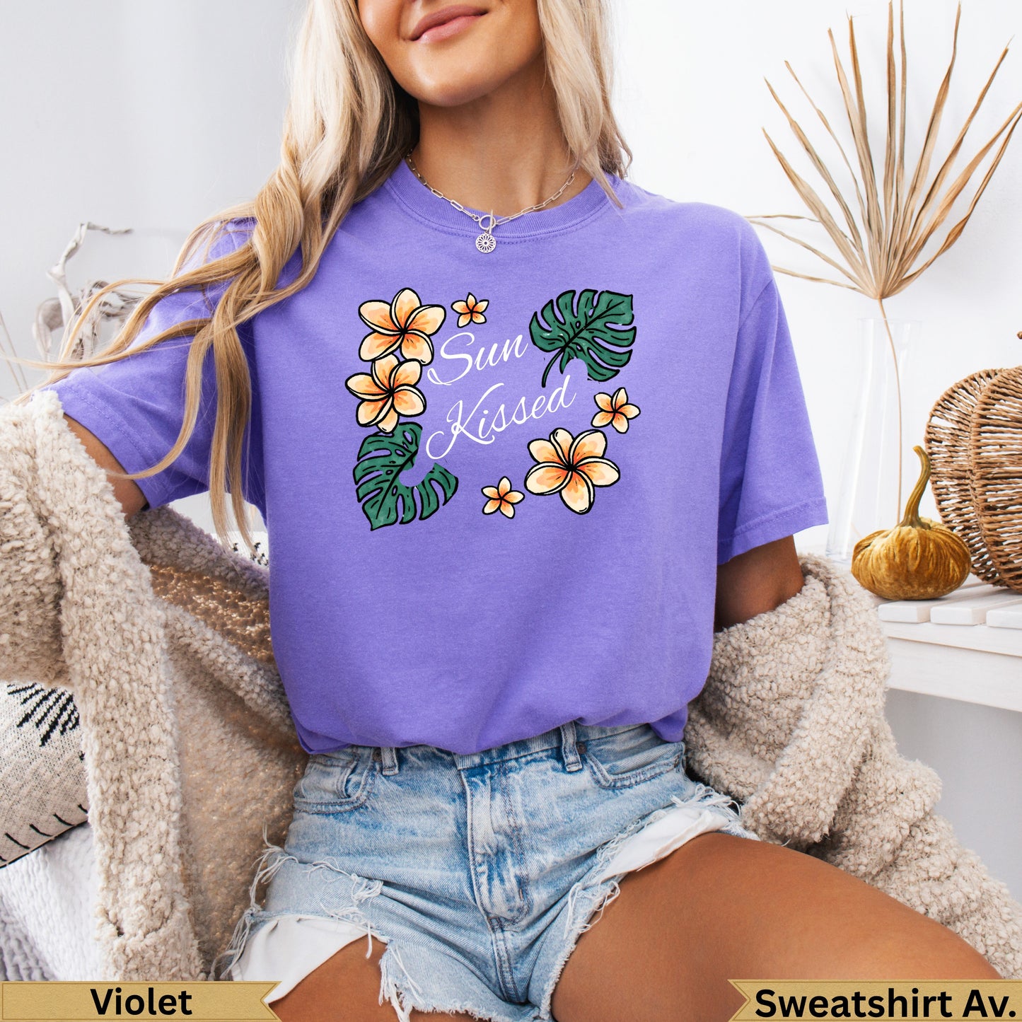 Purple t-shirt with floral "Sun Kissed" graphic.