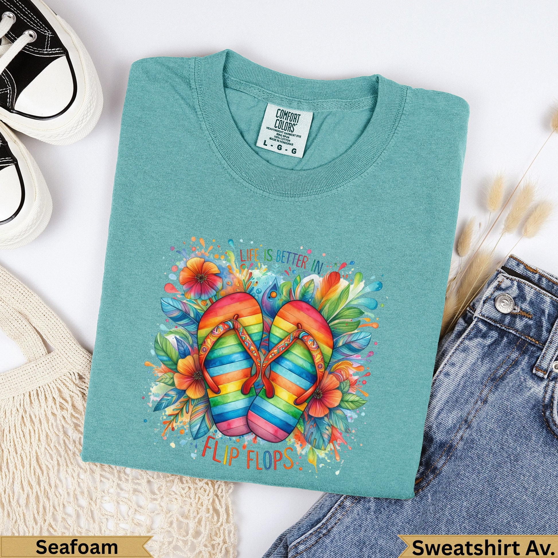 Teal t-shirt with colorful rainbow flip flops and floral design, reads "Life is better in flip flops".
