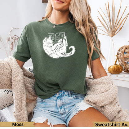 Green t-shirt with a white line drawing of a cat reading a book.