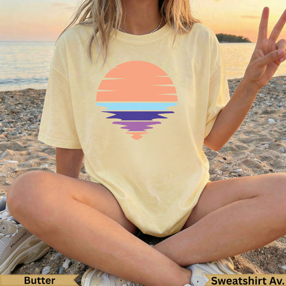 Yellow t-shirt with a pastel sunset graphic and "Butter" and "Sweatshirt Av." text.