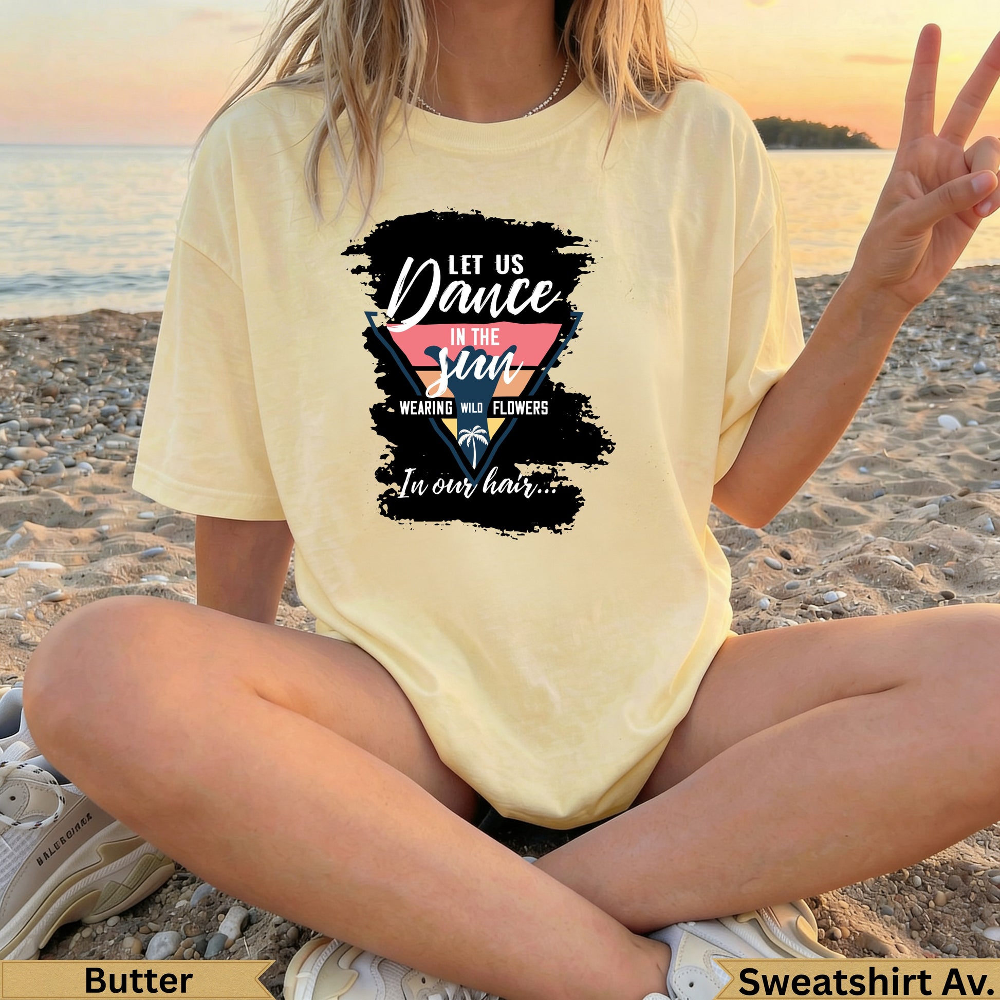 Yellow t-shirt with "Let Us Dance In The Sun" graphic on a beach.